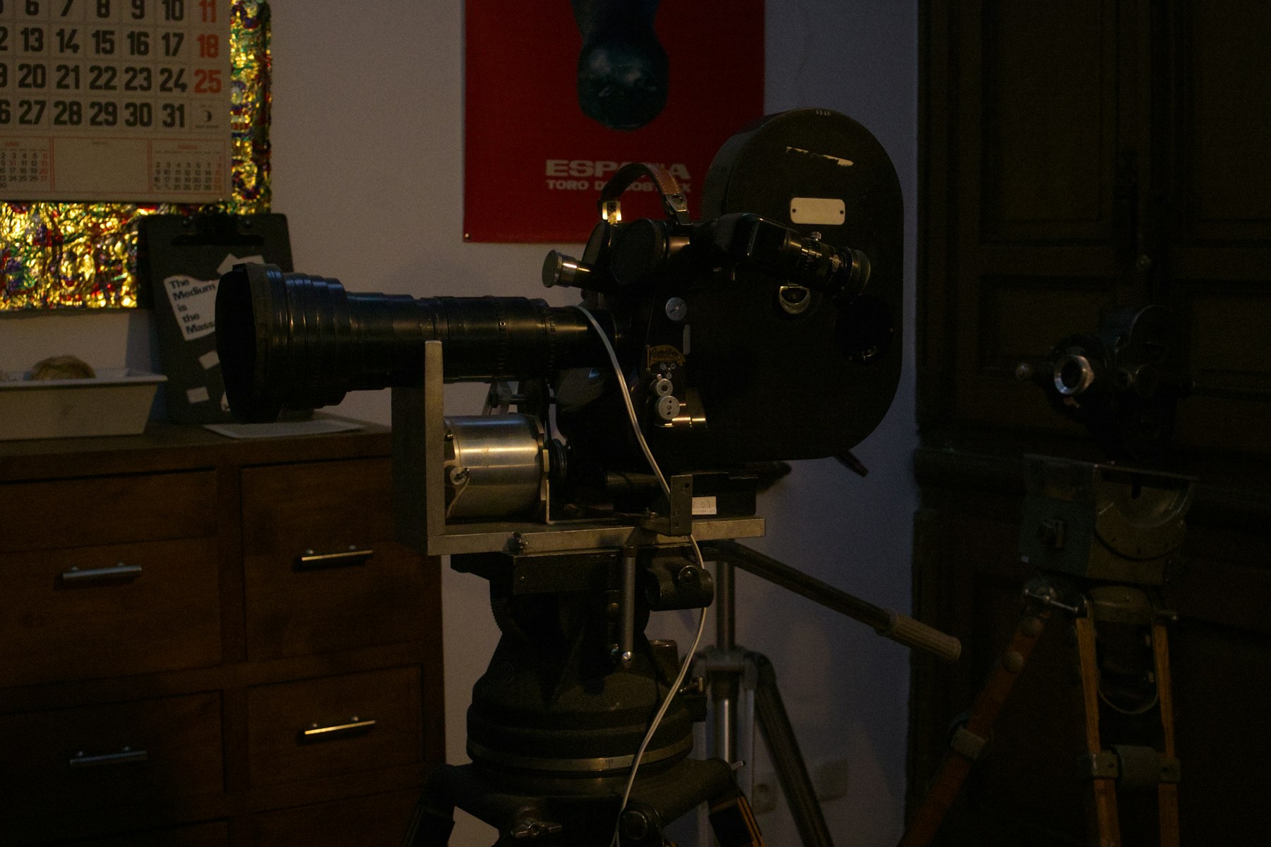 A vintage motion-picture camera in a dark studio